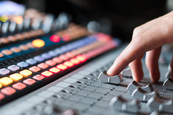 Professional music production in a sound recording studio, mixer desk