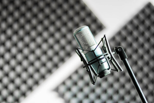 Professional studio microphone in a recording studio, sound insulation in the blurry background