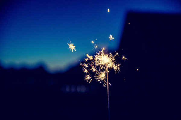 Christmas sparkler on black background. Sparks.