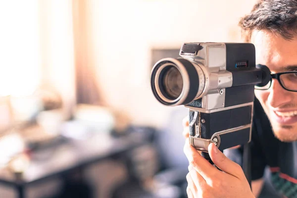 Filmmaker is doing a movie, vintage old movie camera