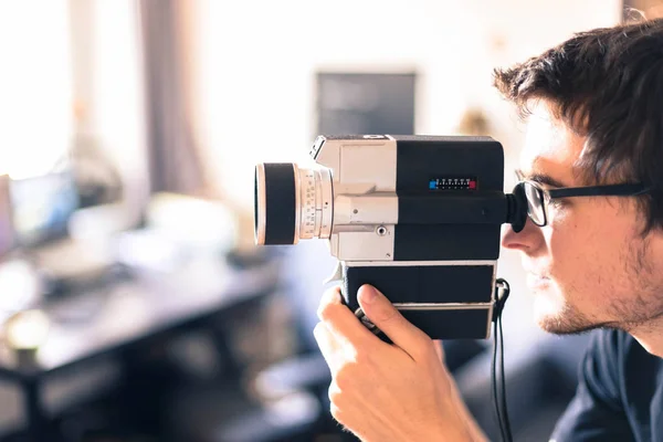 Filmmaker is doing a movie, vintage old movie camera