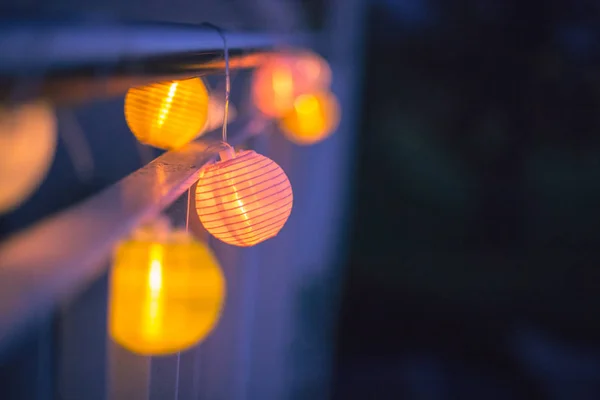 Colorful lampions outside, twilight hour, garden party