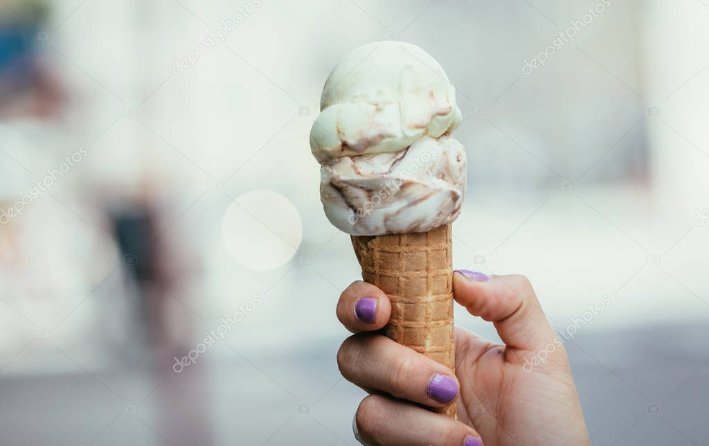 Woman holds ice in her hand, beautiful summer day
