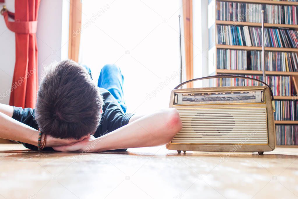 Young man listeining to an retro radio