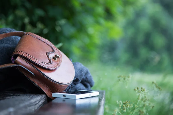 Brown Leather Handbag White Smartphone Jacket Lying Park Bench Nobody — Stock Photo, Image