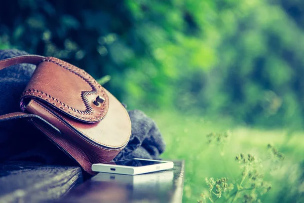 Brown Leather Handbag White Smartphone Jacket Lying Park Bench Nobody — Stock Photo, Image