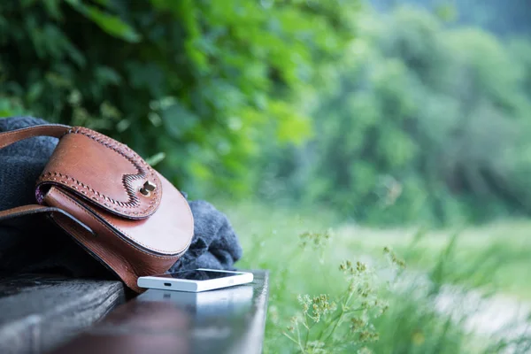 Brown Leather Handbag White Smartphone Jacket Lying Park Bench Nobody — Stock Photo, Image