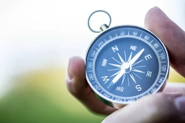 Compass holding in the hand, outdoor adventure