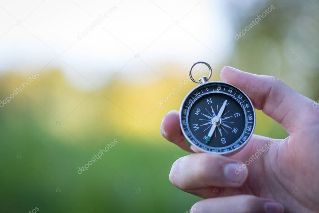 Compass holding in the hand, outdoor adventure