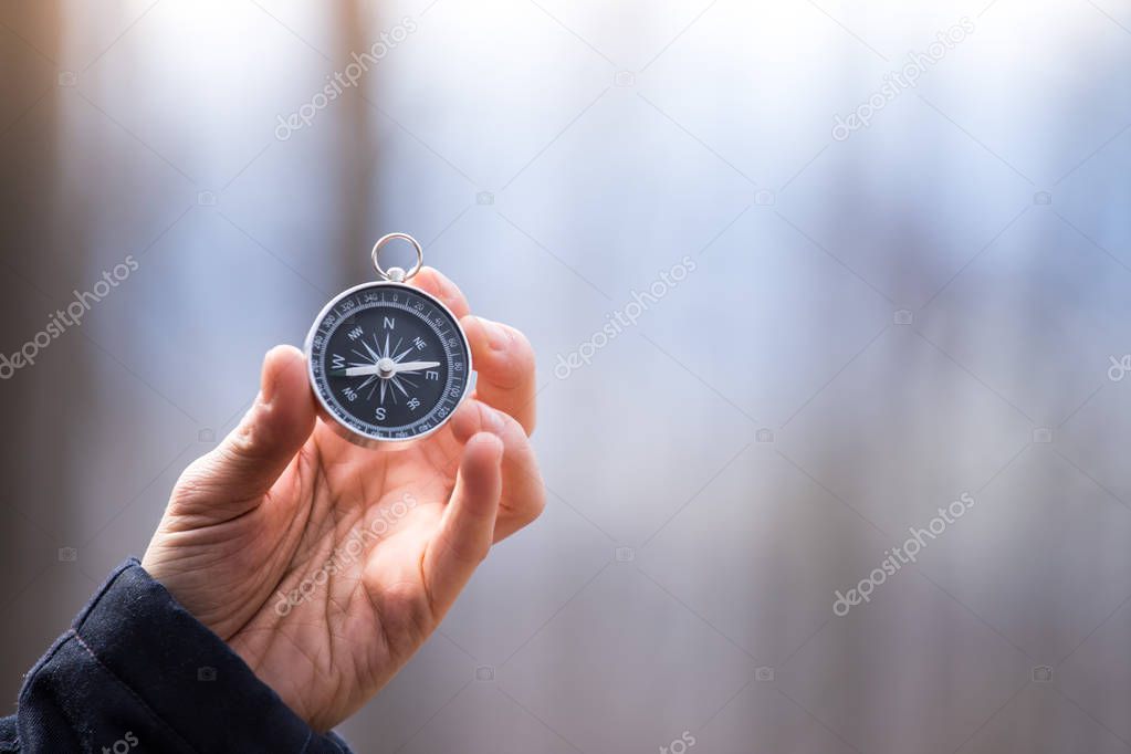 Compass holding in the hand, outdoor adventure