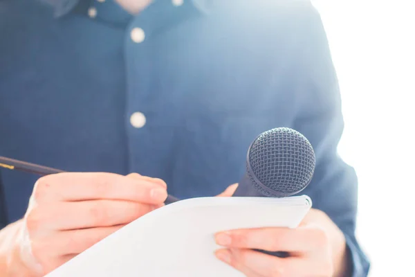 Manlig journalist på presskonferens, hålla mikrofonen och takin — Stockfoto