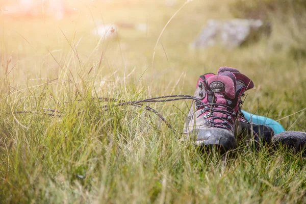 Botas alpinas estão deitados na grama, caminhadas viagem — Fotografia de Stock