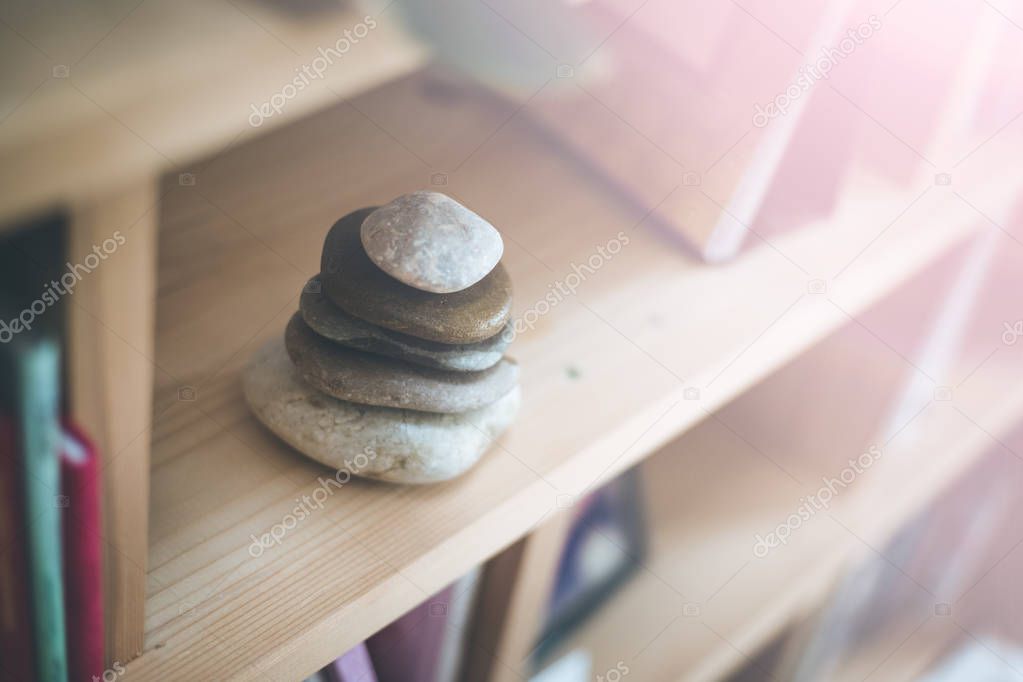 Feng Shui: Stone cairn in a book shelf in the living room, balan