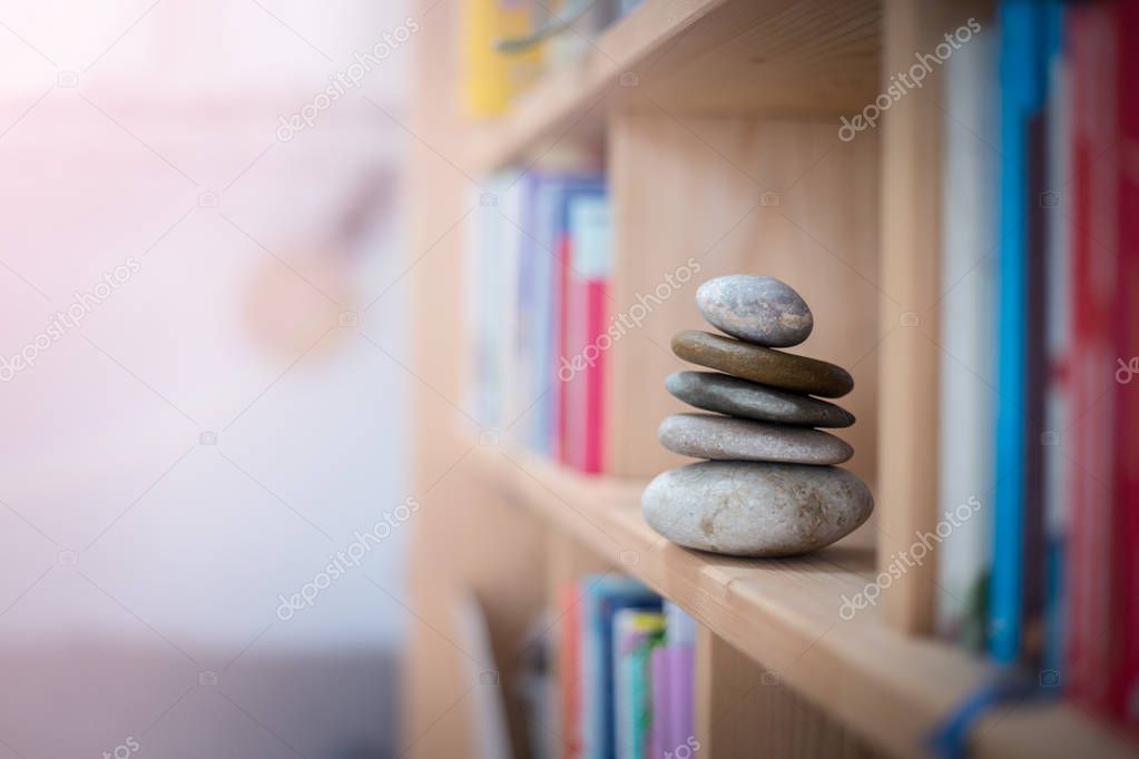 Feng Shui: Stone cairn in a book shelf in the living room, balan