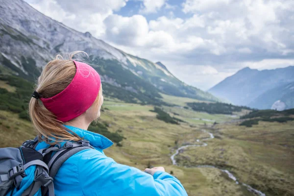 Vrouwelijke blonde bergbeklimmer met rugzak is genieten van de vie — Stockfoto