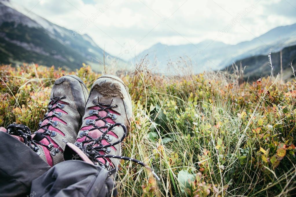 Alpine boots in foreground, idyllic mountain landscape in the bl