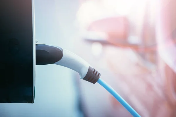Churching an electric car with power cable supply, plugged in — Stock Photo, Image
