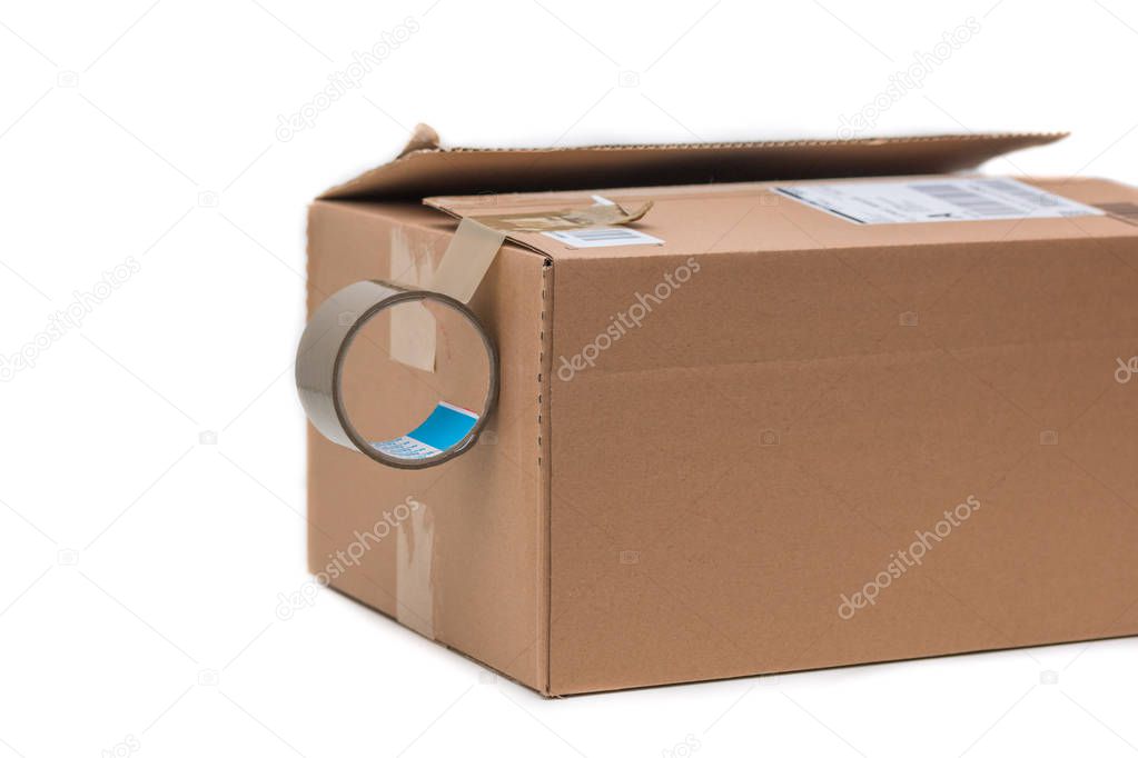 Shipping concept: Cardboard box and sticky tape