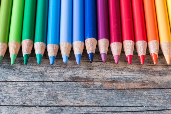 Kreativitás: Multi-színes ceruzák rusztikus, fából készült asztal — Stock Fotó