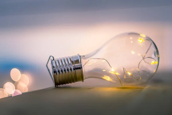 Ideas and innovation: Light bulb with LEDs is lying on a wooden