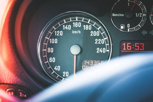 Sports car dashboard and steering wheel with tachometer and fuel