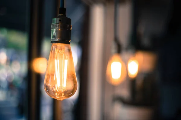 Lightning in the restaurant Close up of a hanging, orange light — Stock Photo, Image