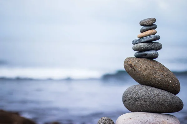 Balance, relaxation and wellness: Stone cairn outside, ocean in