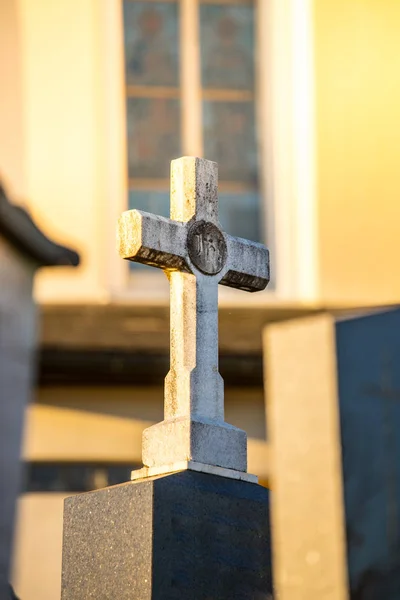 Stone cross on the cemetery, evening sun — Stock Photo, Image