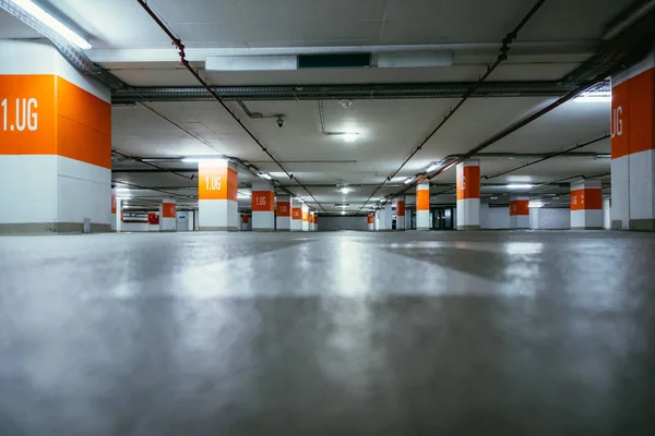 Parking garage in the underground. Asphalt and empty parking lot