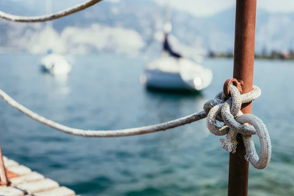 Sailing: Wooden dock pier, sailing boats in the background. — Stock Photo, Image