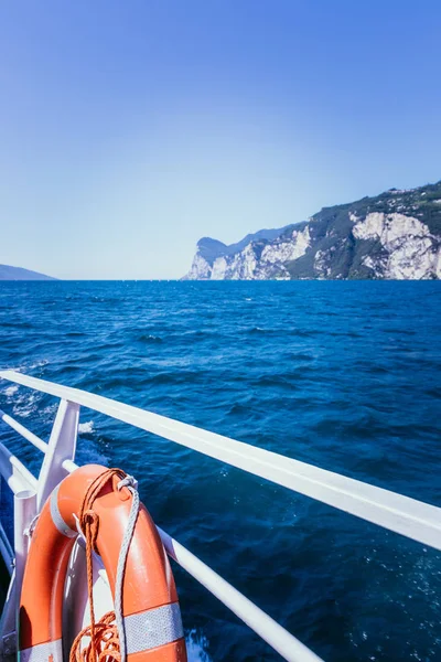 Boat tour: Boat railing, view over azure blue water and mountain