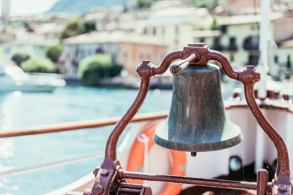 Boat tour: Boat bow with boat bell, view over azure blue water,