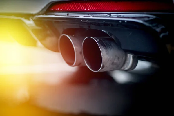 Powerful car with exhaust pipe, pollution and fine dust. Sunligh — Stock Photo, Image