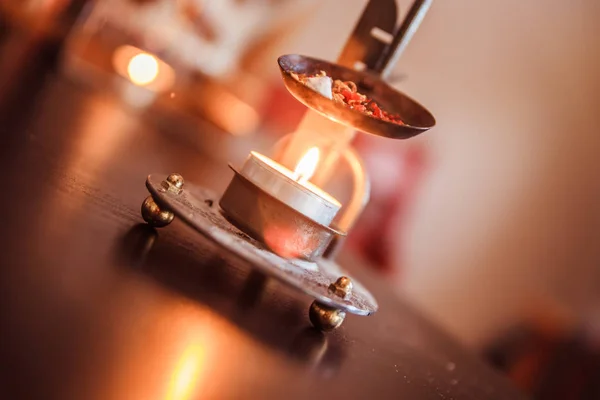 Christmas time: Candle with incense, Christmas tree and presents — Stock Photo, Image