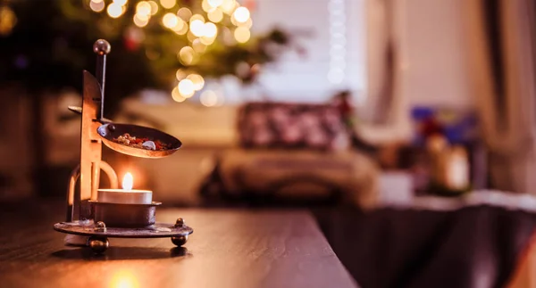 Christmas time: Candle with incense, Christmas tree and presents — Stock Photo, Image