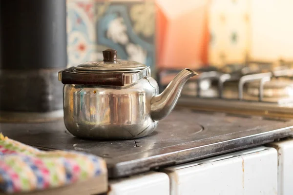 Cooking tea in winter time: rustic iron tea cooker
