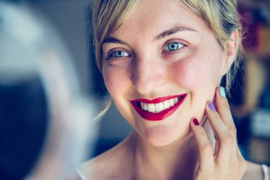 Çekici kırmızı dudak sopa ve sağlıklı beyaz dişler: Sarışın genç w