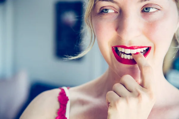 Attractive red lip stick: Blonde young woman with colorful nail