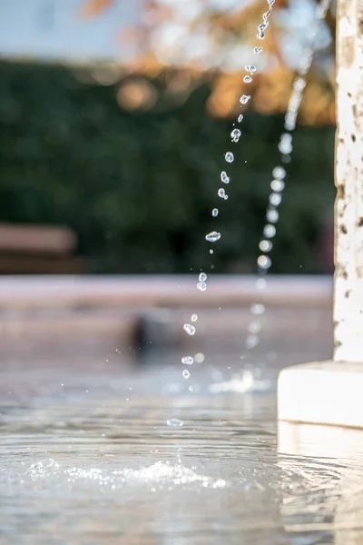 Water drops falling in well — Stock Photo, Image
