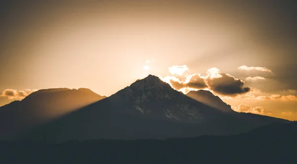 Sunset on a mountain, light beams