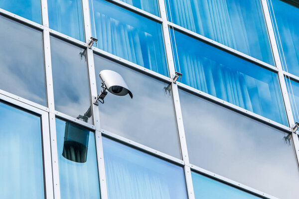 glass architecture of modern building with secure camera