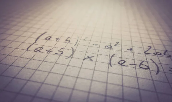 mathematical formulas are written in a notebook