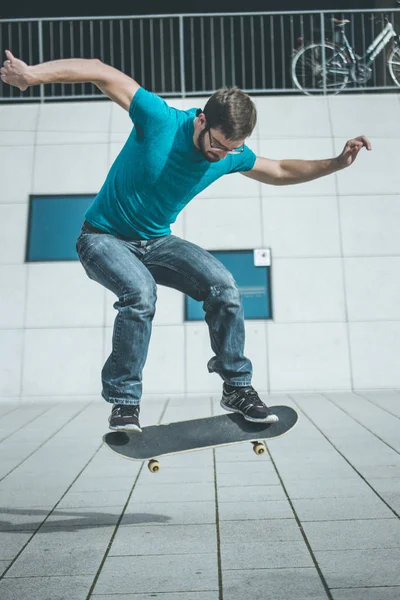 Mężczyzna Deskorolkarz Robi Skok Trick — Zdjęcie stockowe
