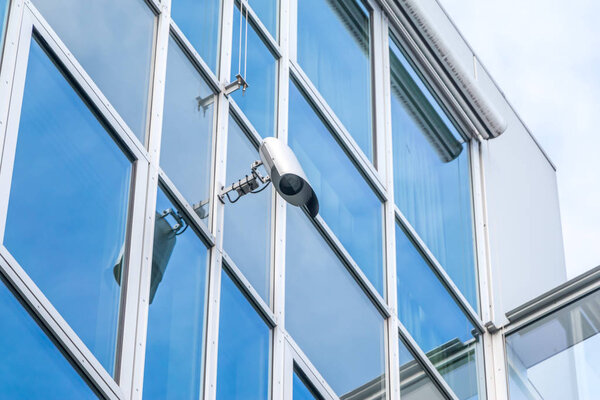 glass architecture of modern building with secure camera