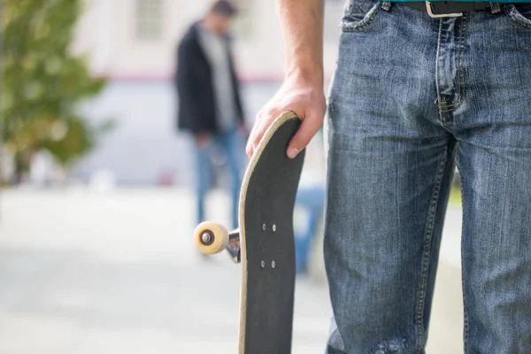 man in  sneakers with a skateboard