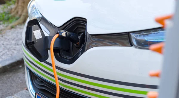 Electric car recharging with charge cable and plug leading to charge point