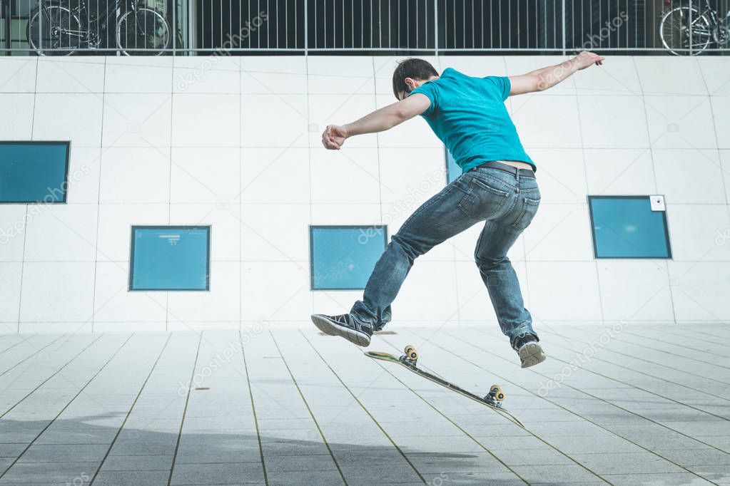male skateboarder doing jump trick