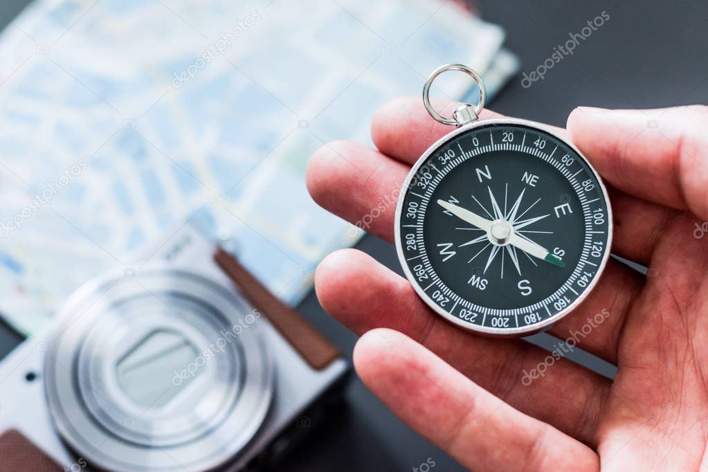 Vintage compass in mans hand, adventure and discovery concept  