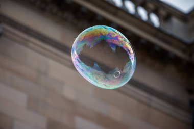 Colored soap bubble flying in town