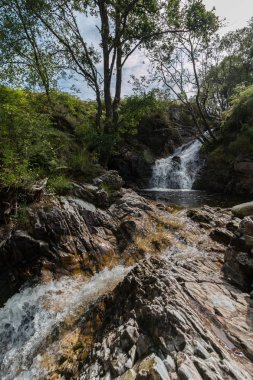 Dağlarda şelale doğa manzarası arka planında